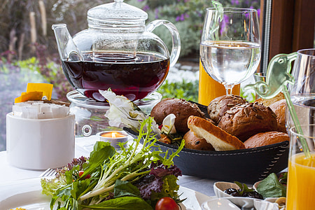 brow breads on black bowl near wine glass and pitcher during day time thumbnail