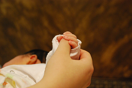 baby wearing white long-sleeved top thumbnail