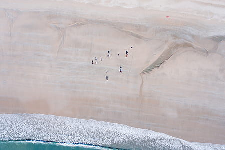 aerial photography of sand near body of water thumbnail