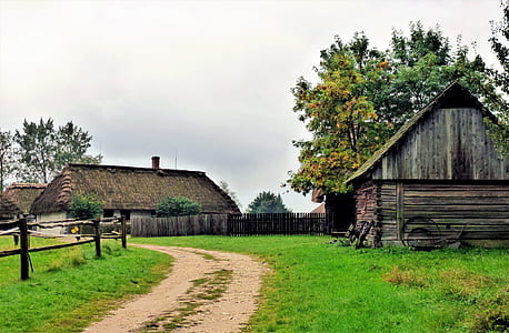 brown wooden house on green grass field thumbnail