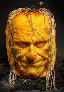 man's face carved pumpkin on black floor thumbnail