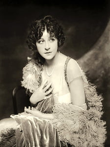 sepia photography of woman sitting on chair thumbnail