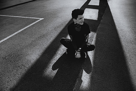 Man sitting on the floor in shadows thumbnail