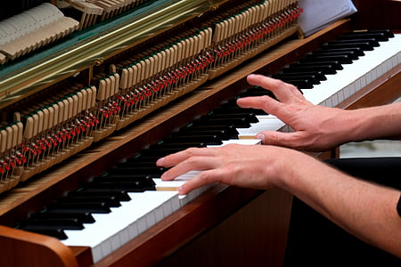 person plays upright piano thumbnail