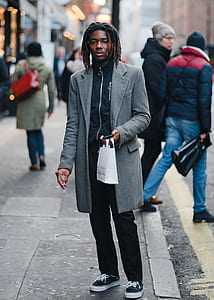 man standing near road thumbnail