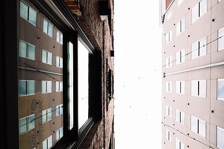 bottom view of two brown concrete buildings thumbnail
