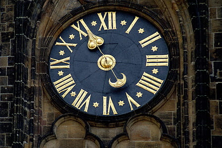 beige tower with blue analog clock at 4:56 thumbnail