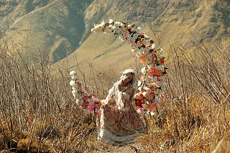 Woman Sitting on Crescent Moon Floral Chair thumbnail