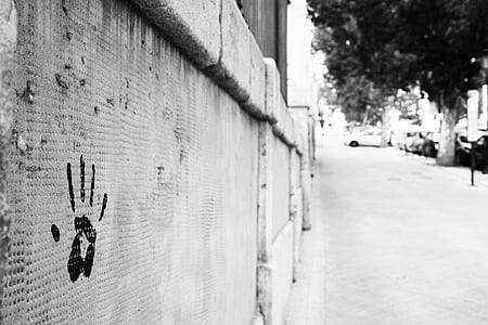 human hand print on concrete wall grayscale photo thumbnail