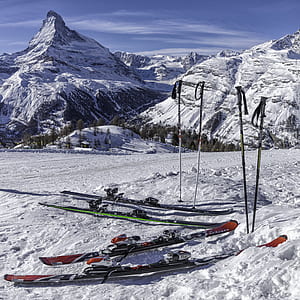 two pairs of ski blades and ski poles thumbnail
