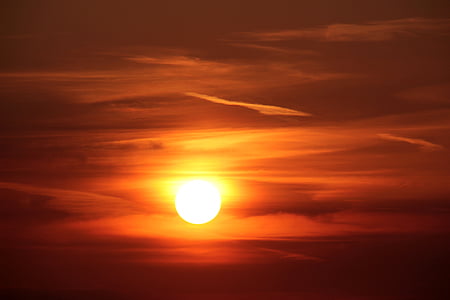 sun under red cloudy sky thumbnail