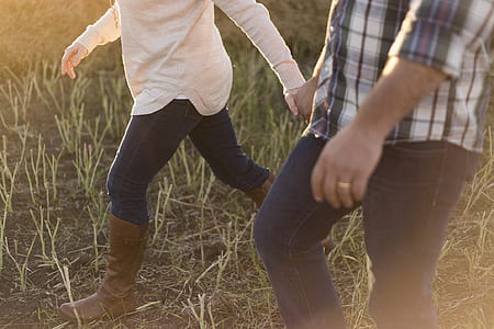 woman walking on field wearing brown mid-calf boots thumbnail