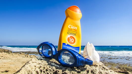 blue diving goggles beside orange plastic bottle thumbnail