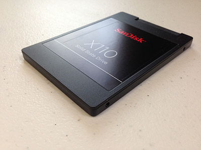 black SanDisk X110 solid state drive on top of white countertop thumbnail