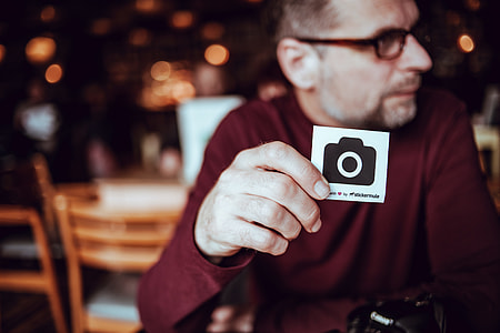 man holding black and white printer paper thumbnail