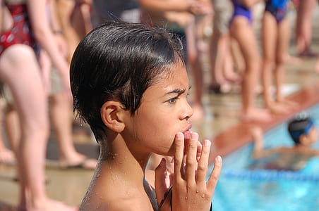 boy putting his hand on his mouth thumbnail