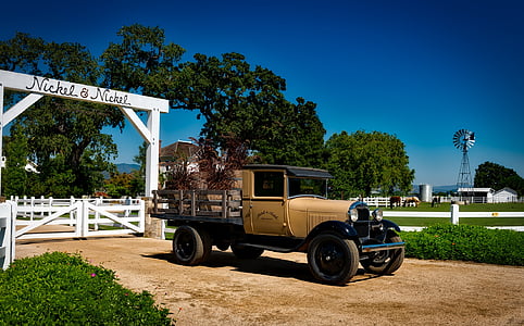 brown vehicle parked near white wooden gate thumbnail
