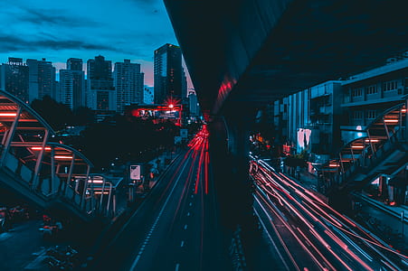 long exposure photograph of concrete road between structures thumbnail
