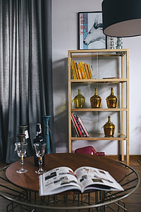 Stylish home decor with a wooden round table and a bookcase thumbnail