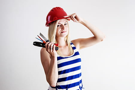 woman wearing blue and white striped tank top and red safety hat thumbnail