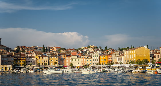multicolored concrete houses near body of water thumbnail