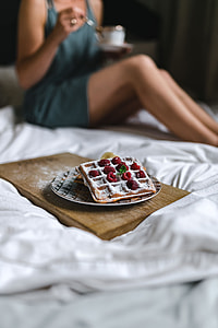 Breakfast in bed - waffles with raspberries and cup of coffee on the tray thumbnail