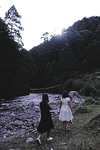 two woman walking near river thumbnail