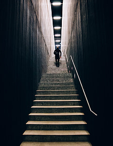 man wearing black jacket climbing on stairs thumbnail