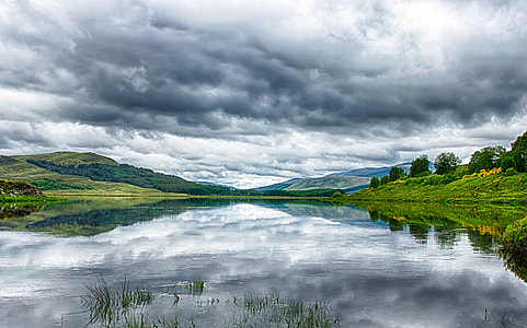 panoramic photography of mountain under gray and white clouds at daytime thumbnail