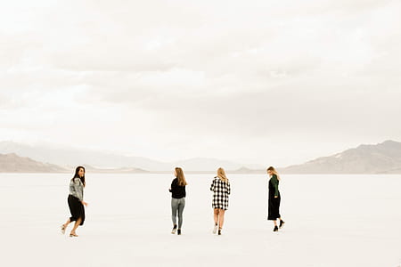 four women walking on snow during winter season thumbnail