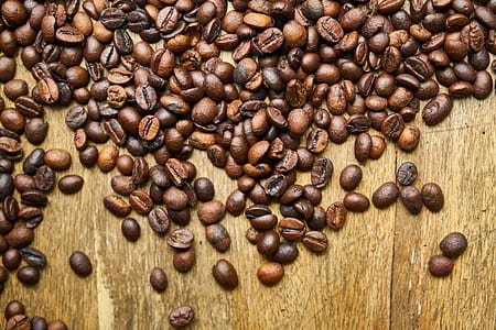 bunch of coffee beans on wooden table thumbnail