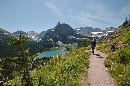Man Walking on Road While on Mountain thumbnail