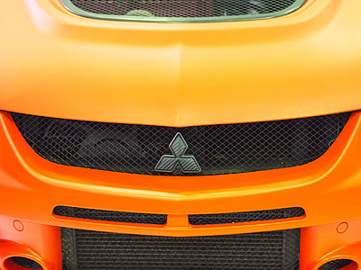 orange and yellow Mitsubishi vehicle thumbnail