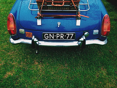 classic blue car parked on green grass field thumbnail
