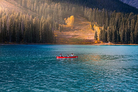 thee person riding on boat on calm water thumbnail