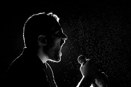 man singing while holding microphone thumbnail