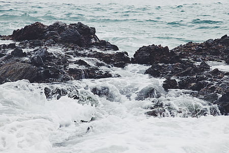 brown rocks on body of water thumbnail