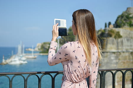 woman holding smartphone standing on handrail thumbnail