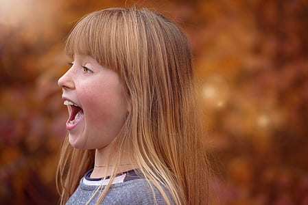 selective photography of girl in grey crew-neck top thumbnail