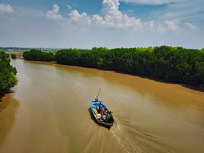 Group of People Riding Boat in Middle of River thumbnail