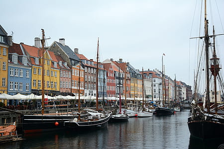 assorted-color boat near dock at daytime thumbnail
