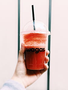 person holding fruit drink thumbnail