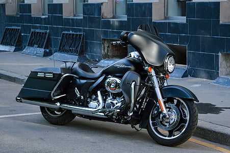 black and chrome touring motorcycle parked on road thumbnail