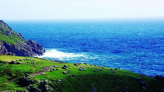 aerial view of cliff near ocean during daytime thumbnail