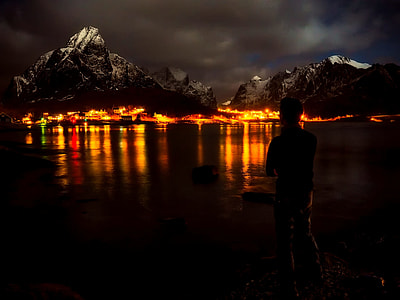 man standing on seashore under dark clouds thumbnail