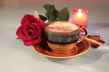 brown ceramic teacup near red rose thumbnail
