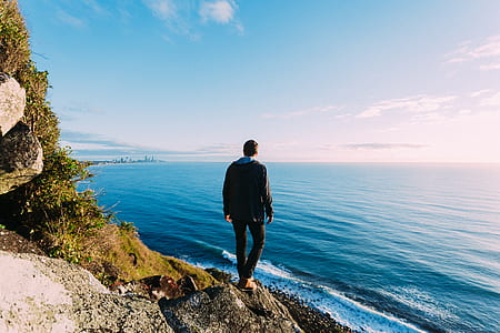 man in black top standing on a cliff thumbnail