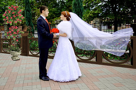man and woman in wedding dress holding hands thumbnail