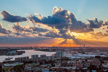 aerial photo of buildings near sea during sunset thumbnail