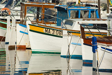 docked assorted-color boats on water at daytime thumbnail